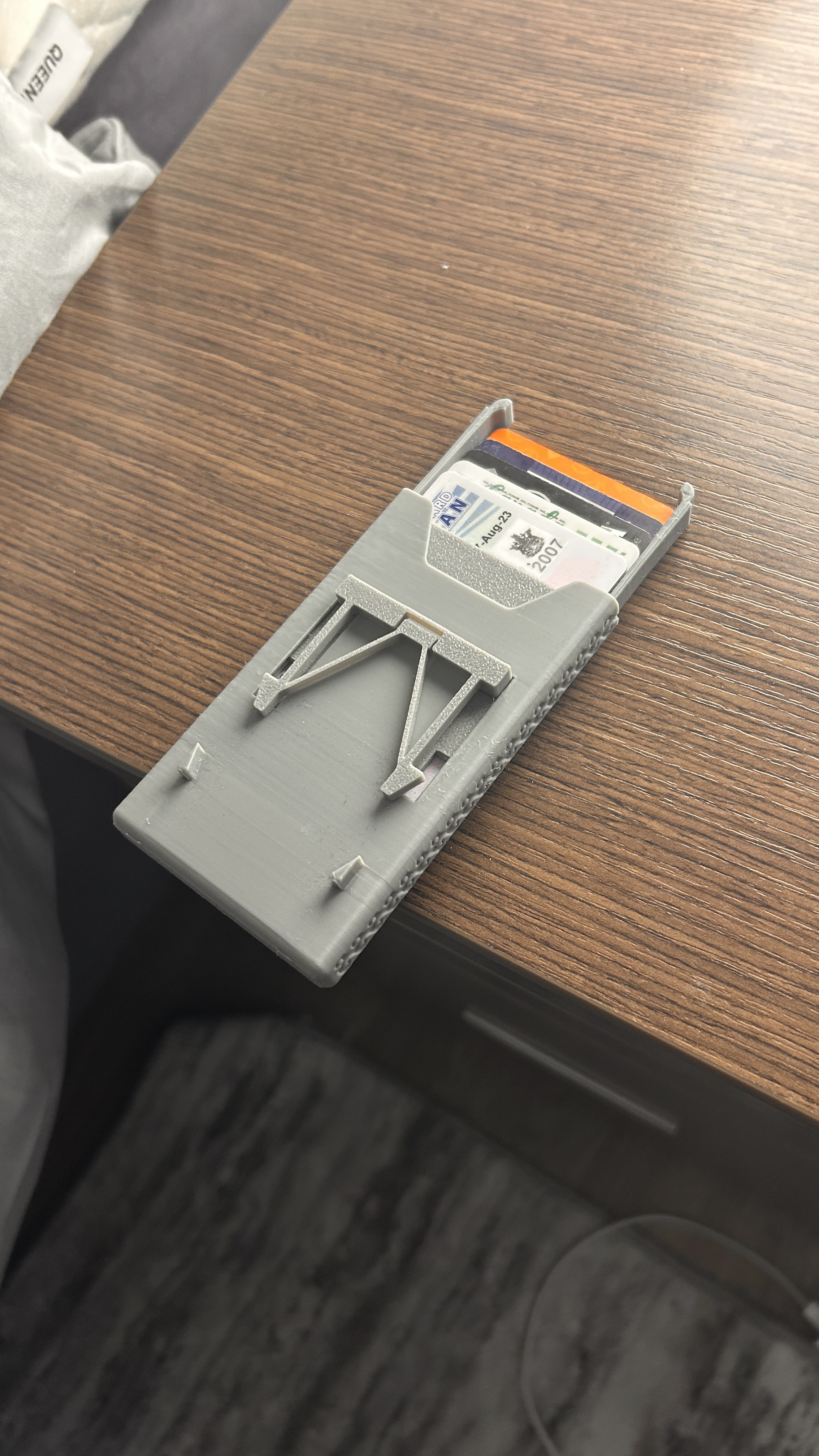 Compact Mechanical Wallet on a desk, cards fanned out