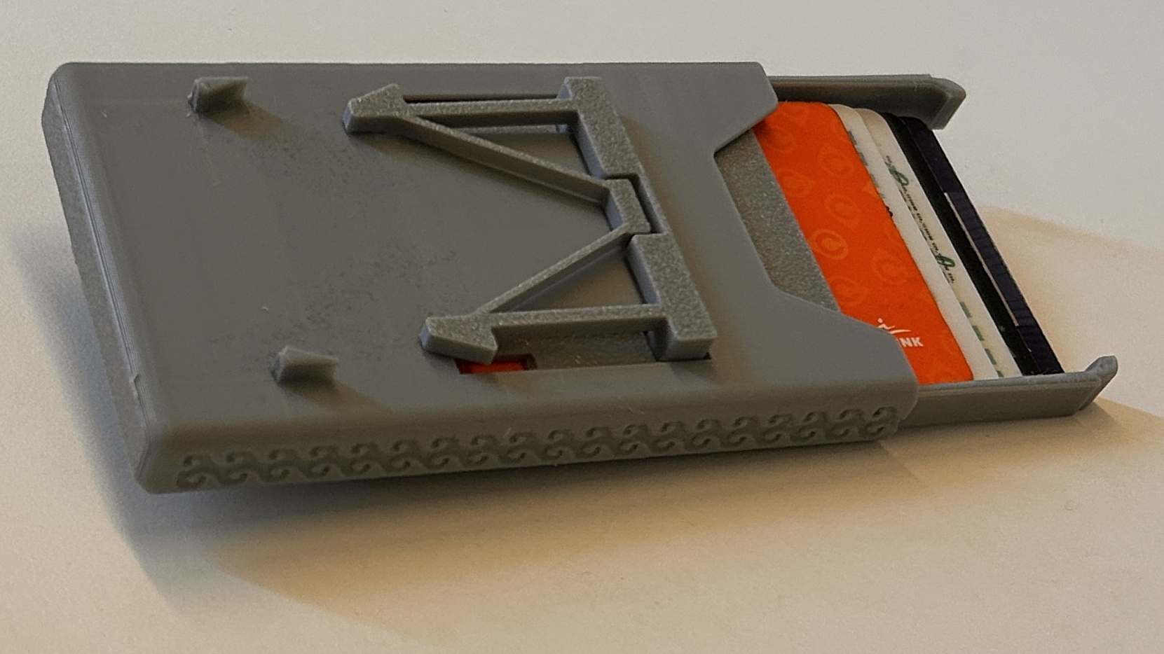 Compact Mechanical Wallet, closed, on a white background